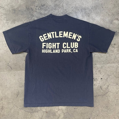 Back of dusty navy tee with creme print that reads "Gentlemen's Fight Club Highland Park, CA"
