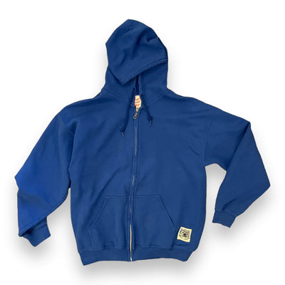 Image of a blue zip up hoodie on white background. The zip up has a small square patch on the right pockets bottom corner. The patch has a woodblock style graphic, of a turtle with a peace sign on its shell wearing a top hat with the sun shining behind it. It reads “ RE-ENERGIZED RECYCLED, EAST / WEST, LOS ANGELES”