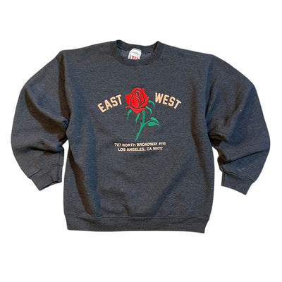 Gray sweatshirt with a red rose graphic and text on a white background