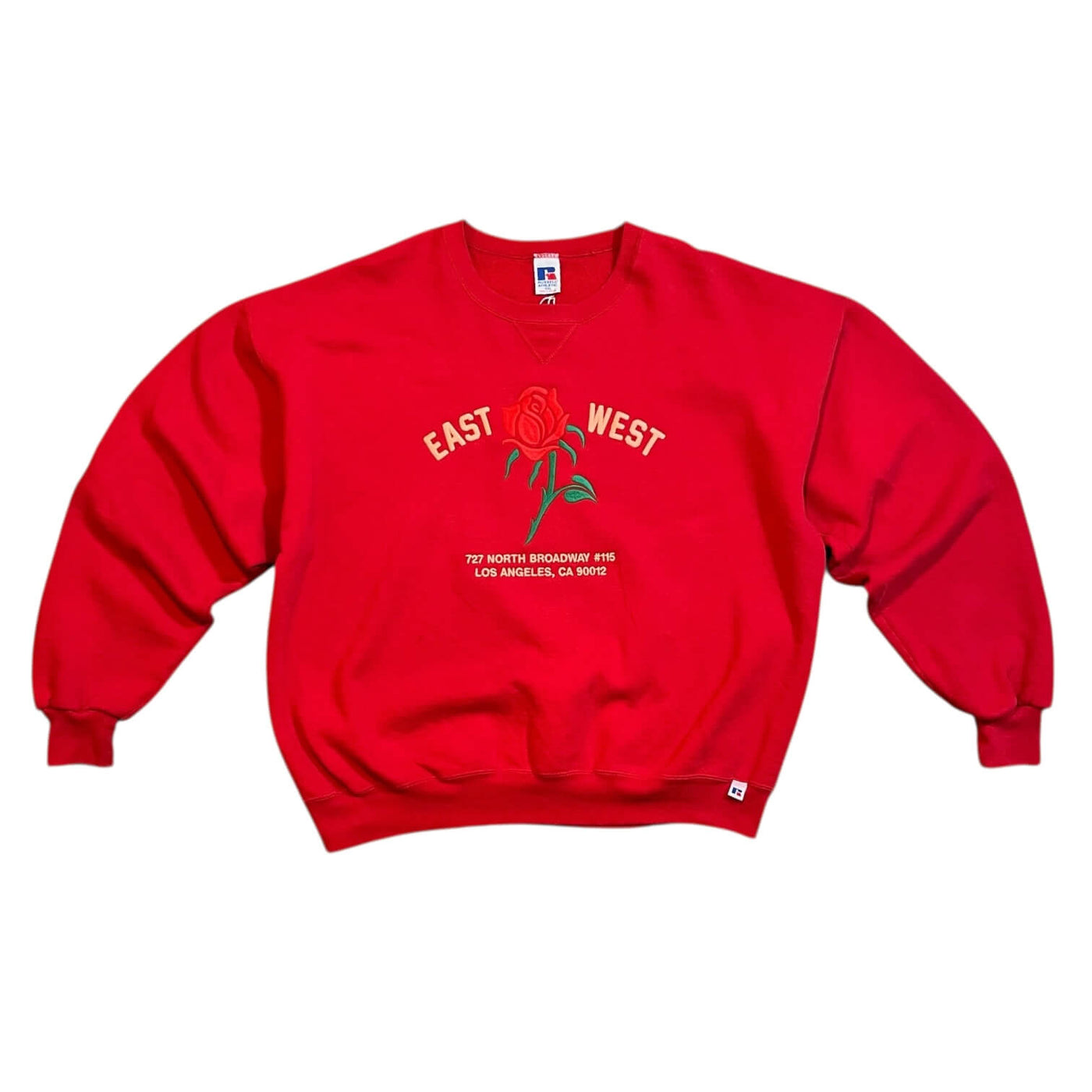 Red sweatshirt with a rose graphic and text on a white background