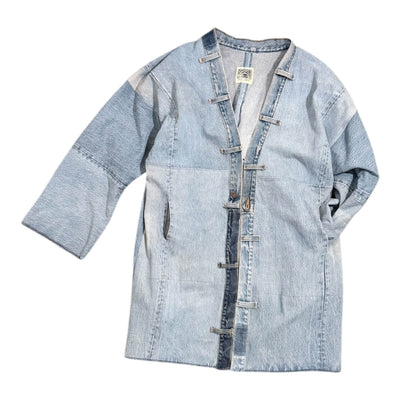 Light blue denim jacket with button details on a white background