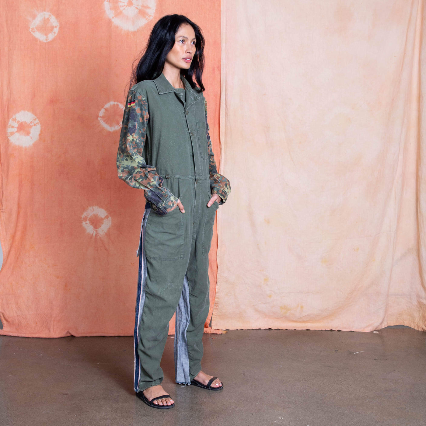 Vietnam Era US Military Jumpsuit on the body, German camo on the sleeves and Denim showing from the back on the legs.  Remade by Tay Trong.