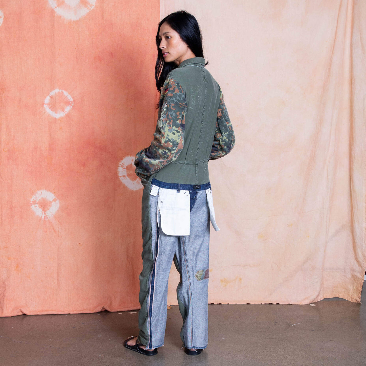 Vietnam Era US Military Jumpsuit on the body, German camo on the sleeves and inside out denim on the back of the legs- showing the pocket bags and APC label.  Remade by Tay Trong.