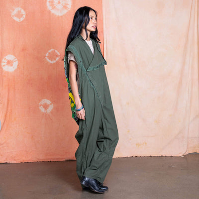 Side view showing reworked sleeveless jumpsuit worn over a T-shirt.