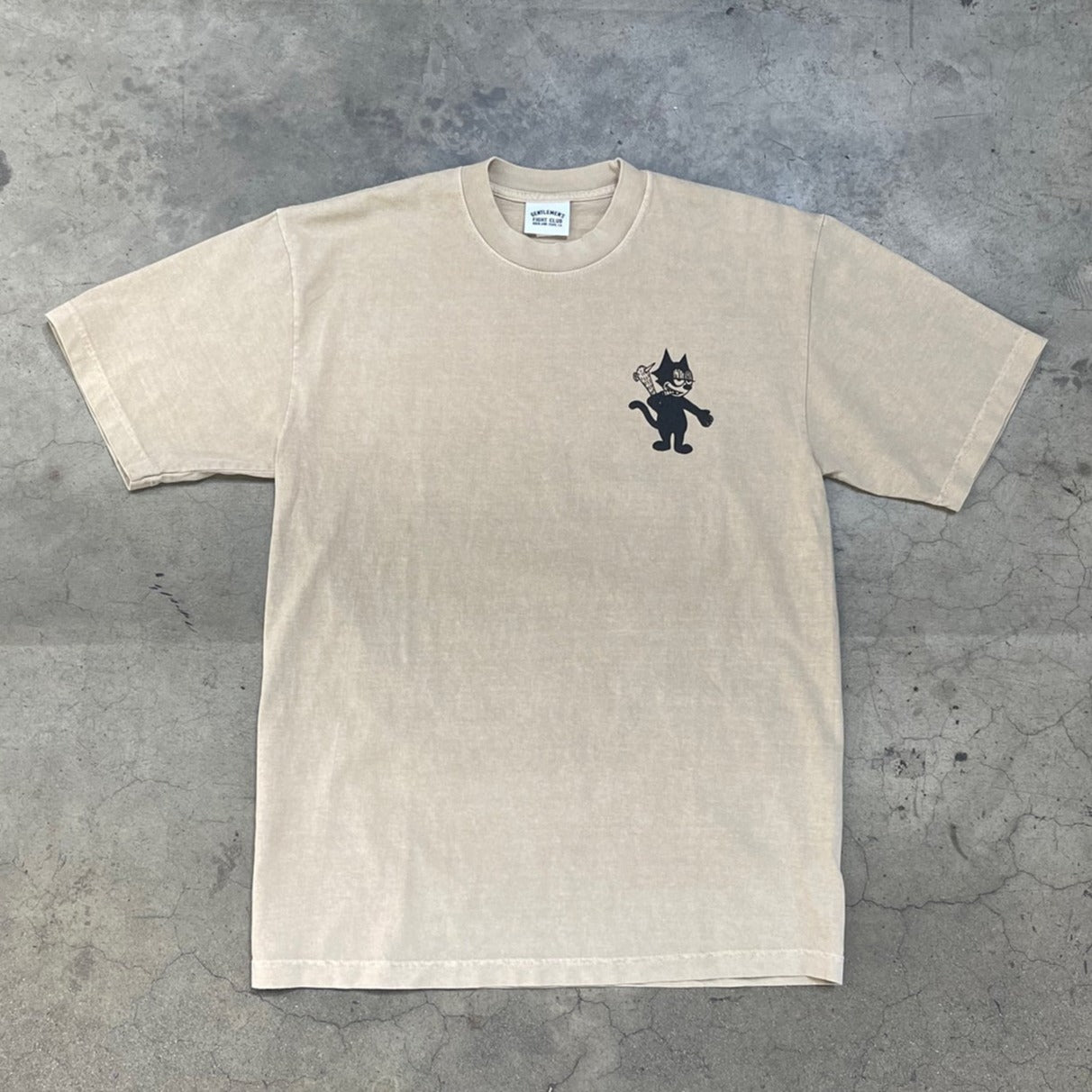 Front of light brown tee with same cat as the back