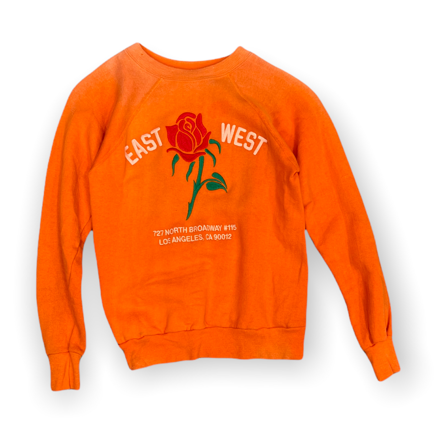Front of orange sweatshirt featuring rose embroidery