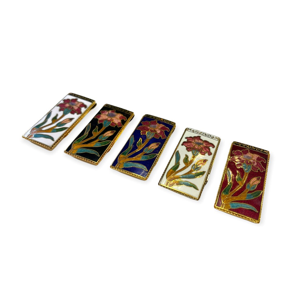Cloisonne colored money clips in the following order from left to right.  White, Black, Blue, Natural, Burgundy. 