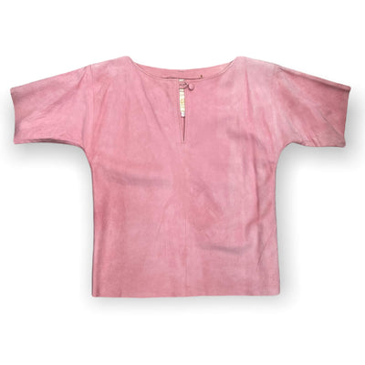 Pink suede top buttoned up at the neck.