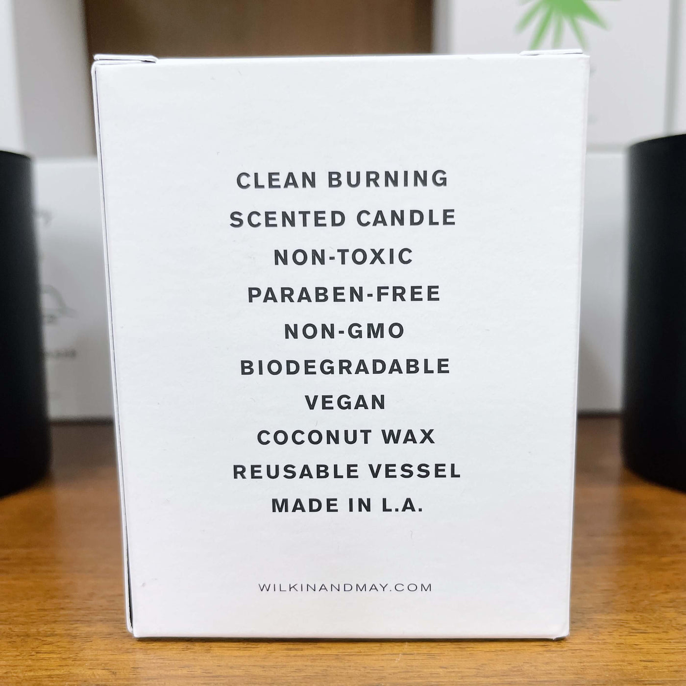 Back of candle box reads clean burning, scented candle, non-toxic, paraben-free, non-gmo, biodegradeable, vegan, coconut wax, resuable vessel, made in L.A.